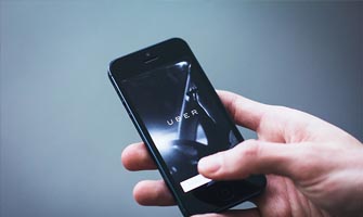 mobile phone with uber logo to accompany article about Uber's terms of service changes